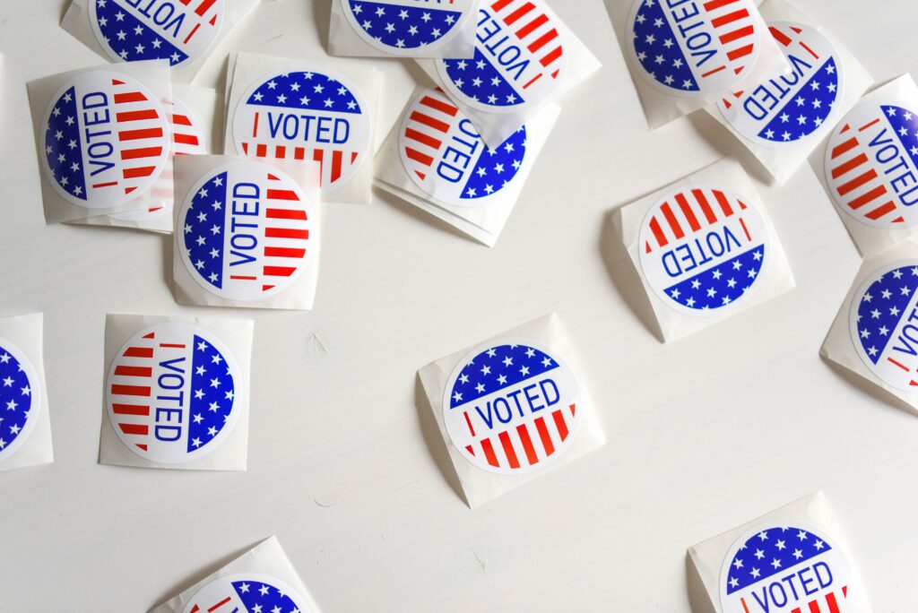 "I voted" badges on a desk