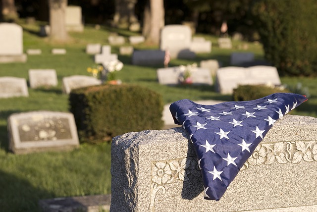 american flag folded on veteran tombstone